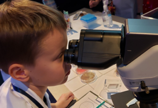 Enfant regardant dans un microscope
