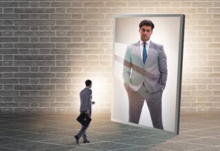 Young businessman in alter ego concept. By Elnur - AdobeStock