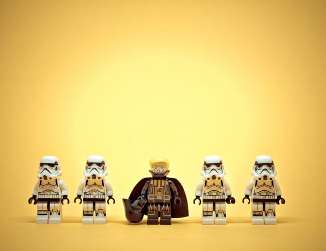 Four stormtroopers are standing in a line with Darth Trump leading them on a yellow background. Illustrative editorial. January 20, 2025. By kirill_makarov - AdobeStock
